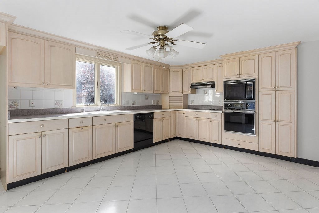 32 Duncan Road Everett, MA 02149 - Photo 12 of 30 a kitchen with a white cabinets appliances and a window