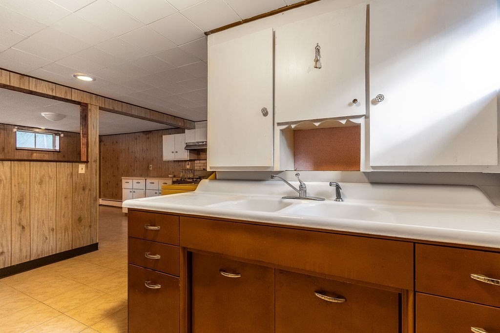 32 Duncan Road Everett, MA 02149 - Photo 18 of 30 a bathroom with a double vanity sink and a mirror