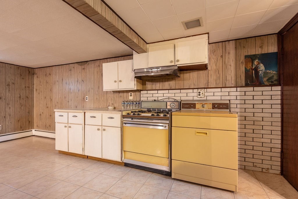 32 Duncan Road Everett, MA 02149 - Photo 19 of 30 a kitchen with stainless steel appliances granite countertop white cabinets sink and a stove