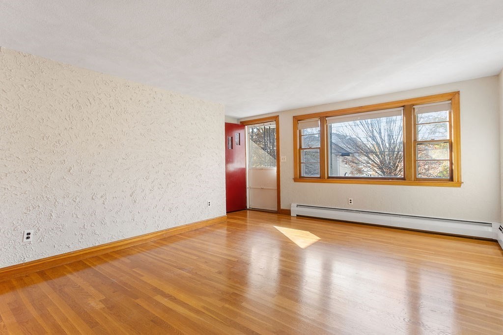 32 Duncan Road Everett, MA 02149 - Photo 2 of 30 an empty room with wooden floor and windows