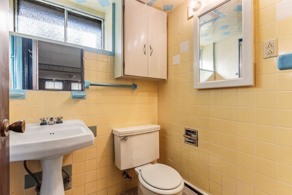 32 Duncan Road Everett, MA 02149 - Photo 23 of 30 a bathroom with a sink a toilet and mirror