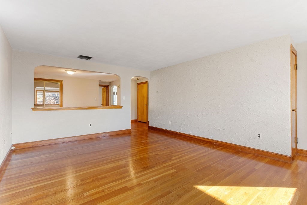 32 Duncan Road Everett, MA 02149 - Photo 3 of 30 a view of an empty room with wooden floor and a window