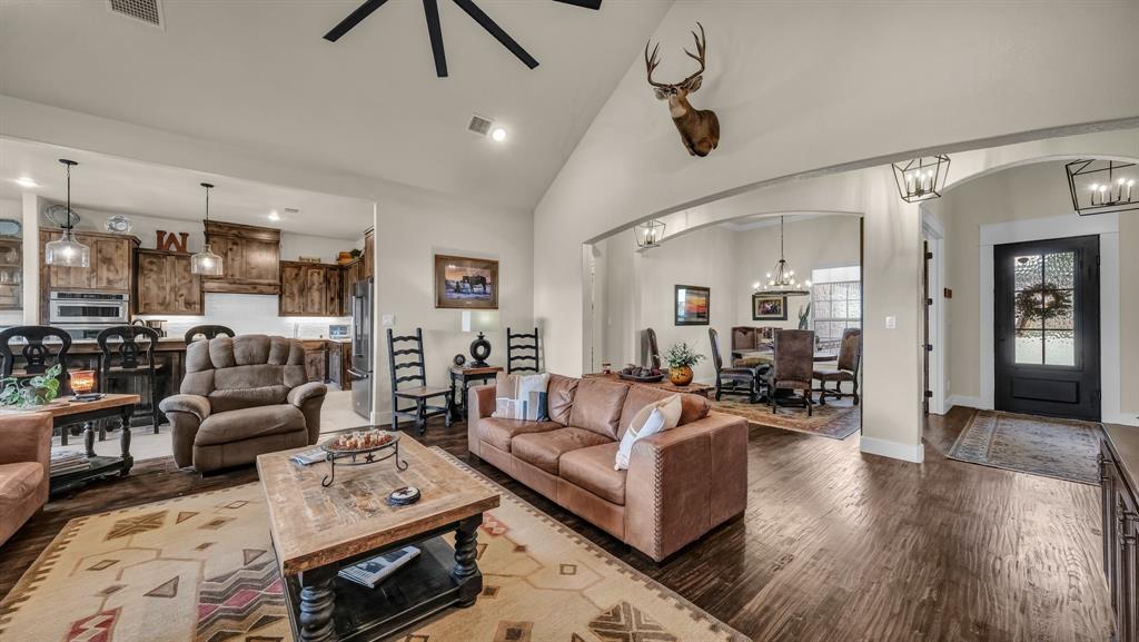 1320 Post Oak Road Gordon, TX 76453 - Photo 15 of 40 Living area featuring high vaulted ceiling, a chandelier, dark wood-style flooring, recessed lighting, and arched walkways