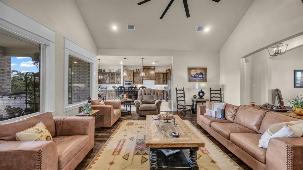 1320 Post Oak Road Gordon, TX 76453 - Photo 16 of 40 Living area featuring wood finished floors, recessed lighting, ceiling fan, high vaulted ceiling, and a chandelier