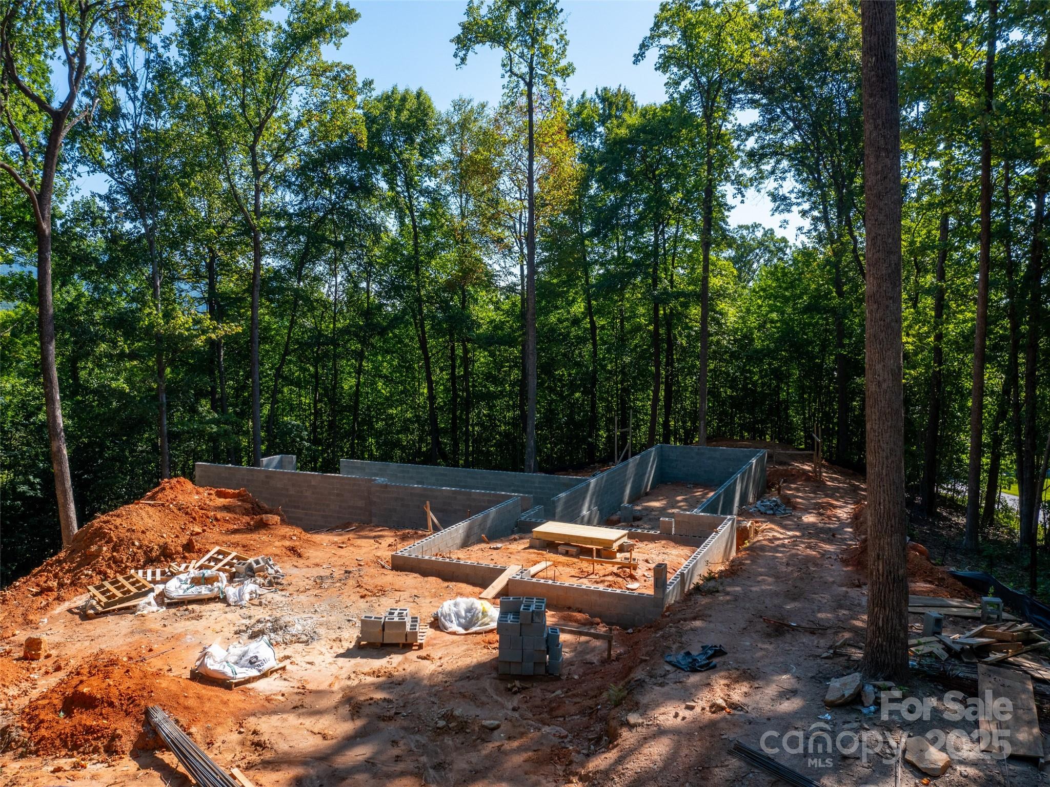 2140 Harm Creek Loop Mill Spring Mill Spring, NC 28756 - Photo 13 of 29 a view of a backyard with lawn chairs and a fire pit
