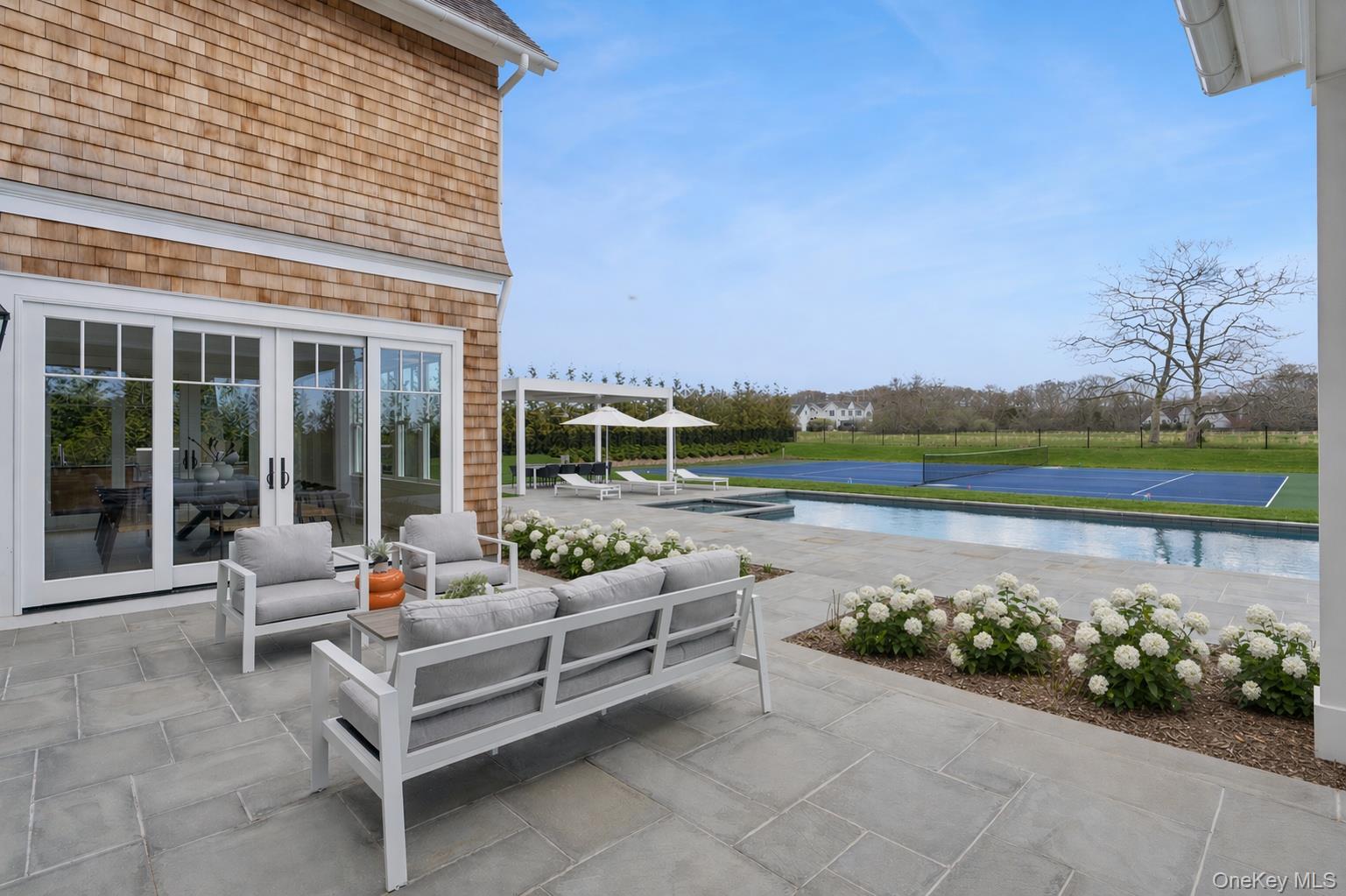 450 7 Ponds Towd Road Water Mill, NY 11976 - Photo 28 of 32 a view of a patio with couches table and chairs and potted plants