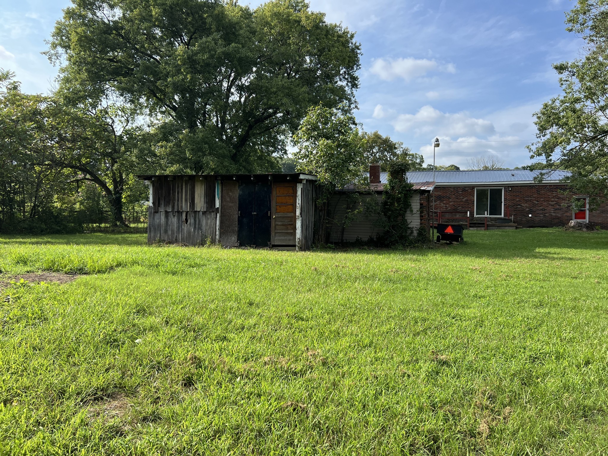 250 Chipman Road Bethpage, TN 37022 - Photo 26 of 32 a view of a white house in front of a big yard with large trees