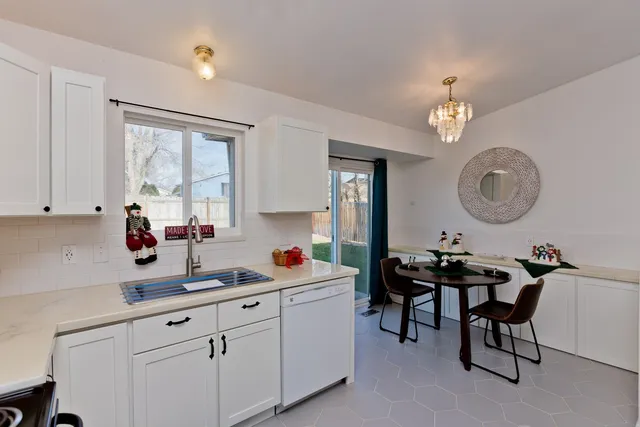 a kitchen with a sink cabinets and window