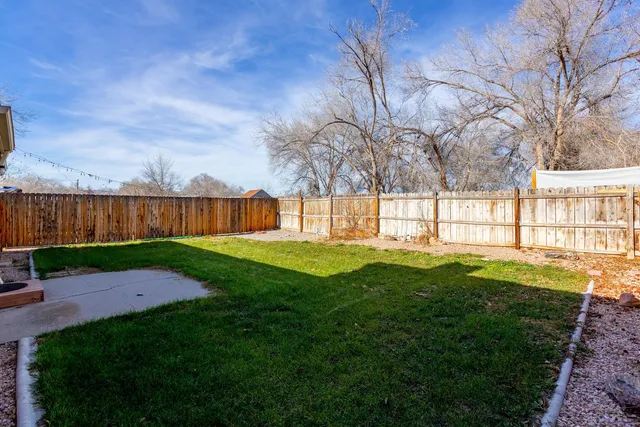 a view of yard with swimming pool and green space