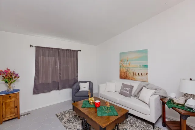 a living room with furniture and flowers