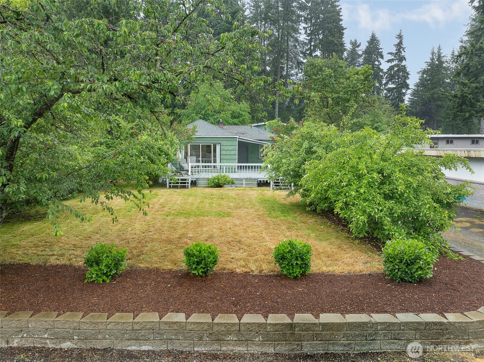 17633 10th Avenue Northeast Shoreline, WA 98155 - Photo 2 of 33 a front view of a house with garden
