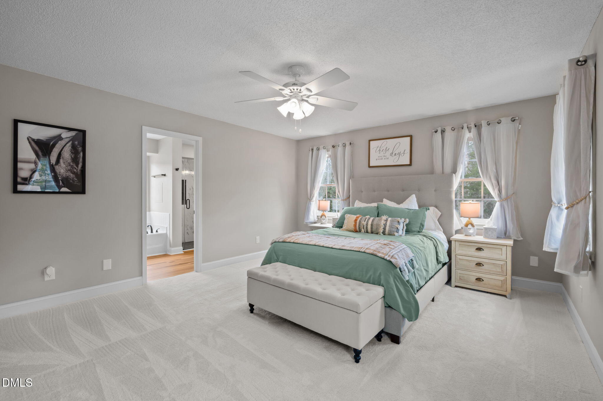 2008 Red Mountain Road Rougemont, NC 27572 - Photo 15 of 31 a spacious bedroom with a bed and a chandelier