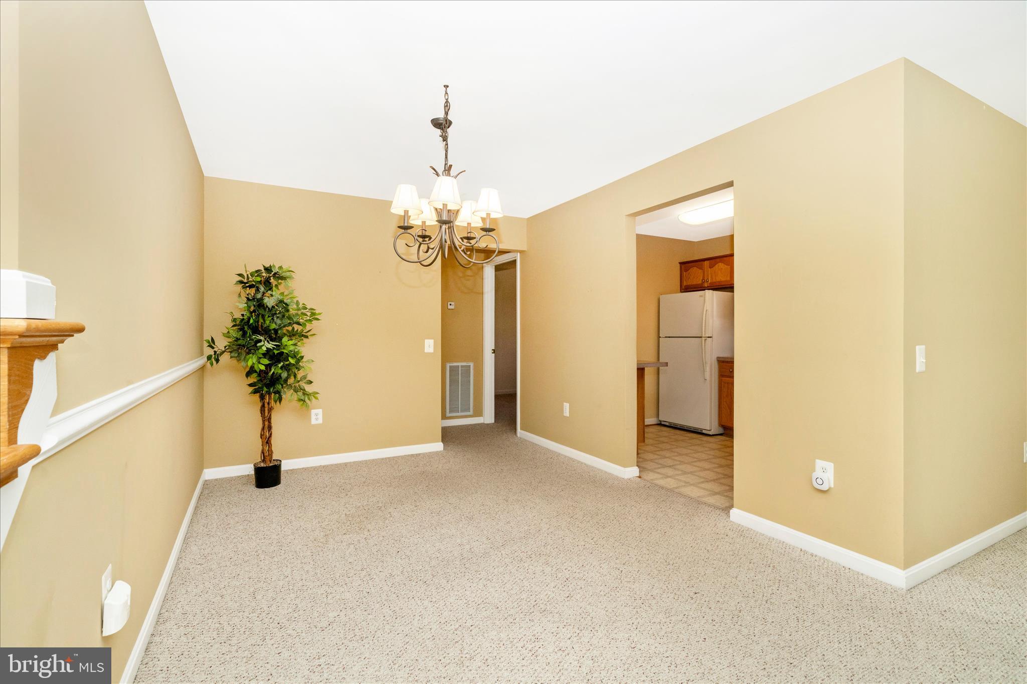 908 Roller Coaster Court Mount Airy, MD 21771 - Photo 12 of 69 a view of a hallway with wooden floor and a chandelier