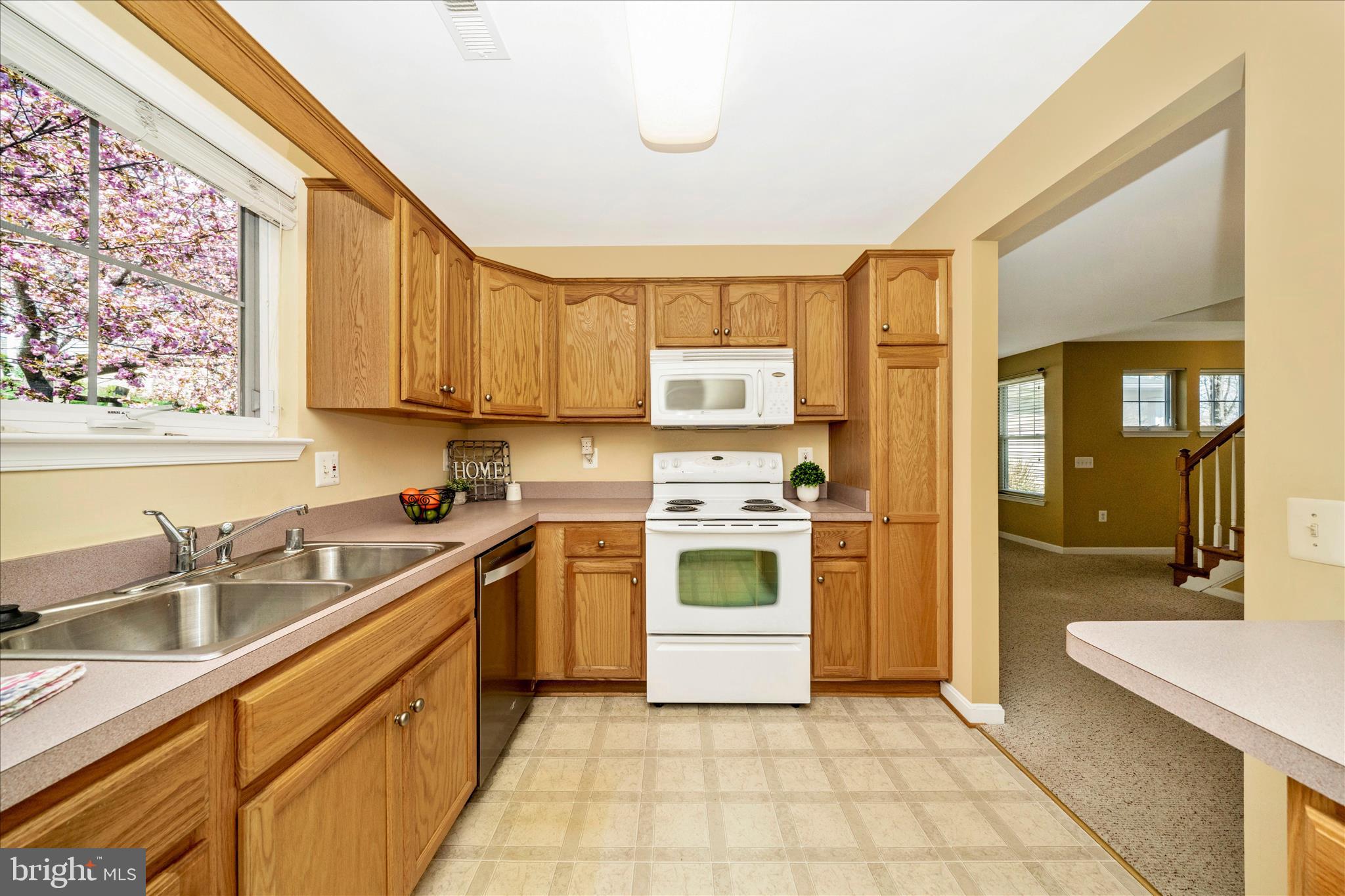908 Roller Coaster Court Mount Airy, MD 21771 - Photo 16 of 69 a kitchen with a sink cabinets stainless steel appliances and a window
