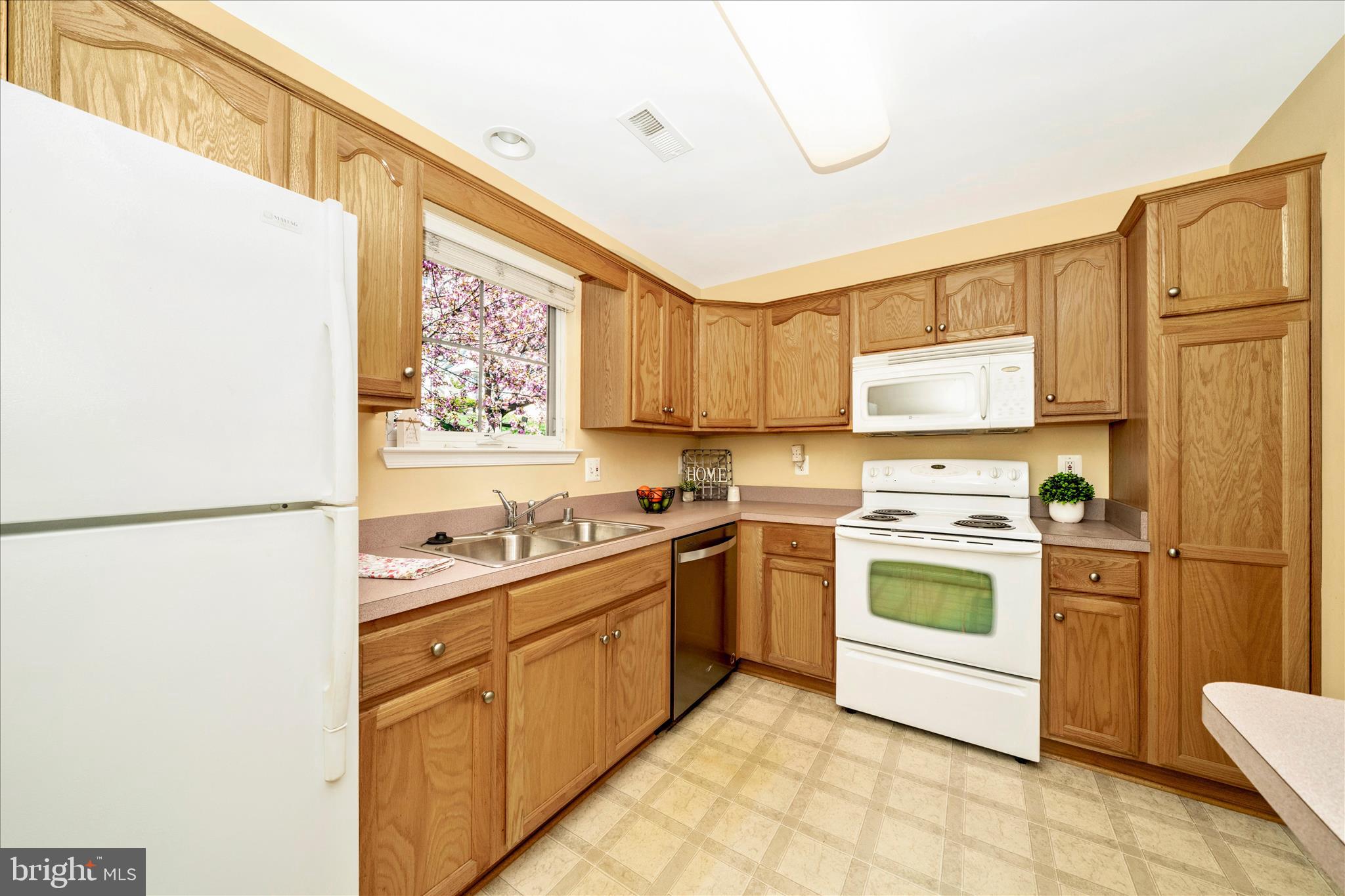 908 Roller Coaster Court Mount Airy, MD 21771 - Photo 17 of 69 a kitchen with white cabinets and white appliances