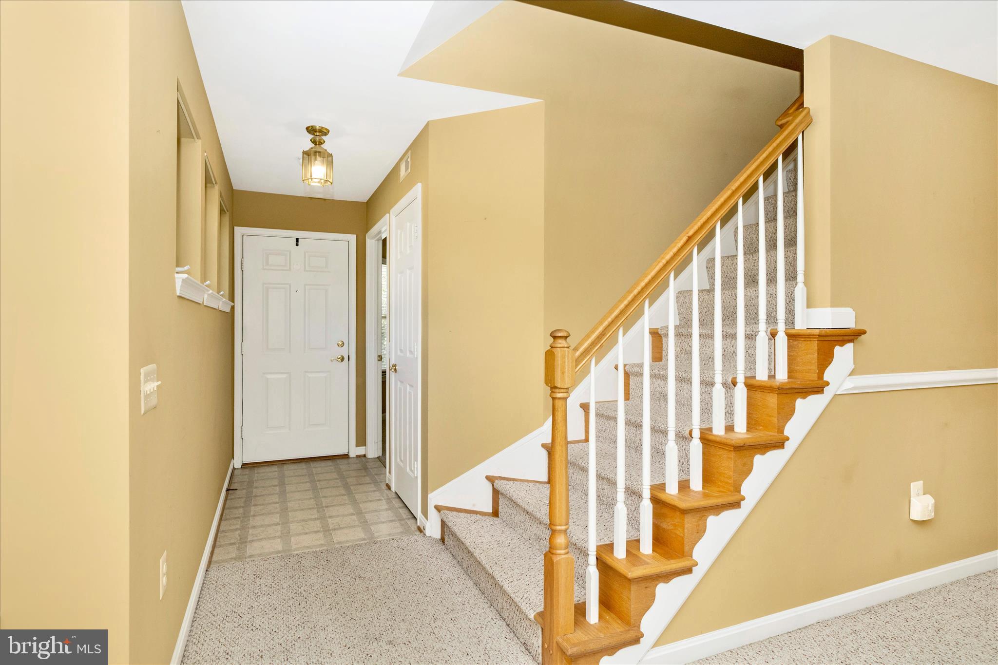 908 Roller Coaster Court Mount Airy, MD 21771 - Photo 6 of 69 a view of a hallway with wooden floor and staircase