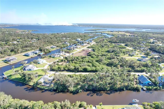 an aerial view of lake and residential houses with outdoor space