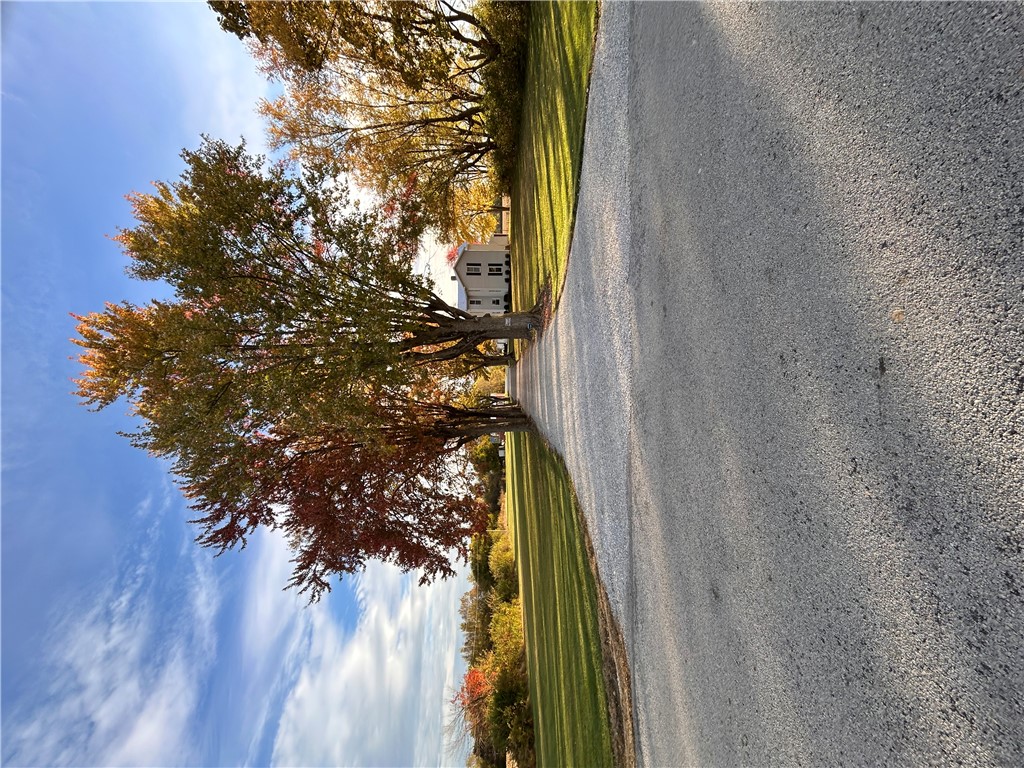 2086 Scheyhing Road Lewisburg, OH 45338 - Photo 27 of 29 This scenic tree-lined driveway leads to a classic white home with a picturesque backdrop.
