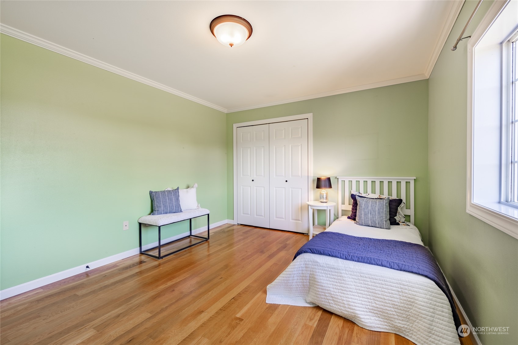 6708 Woodlyn Road Ferndale, WA 98248 - Photo 24 of 40 a bedroom with a bed and a potted plant