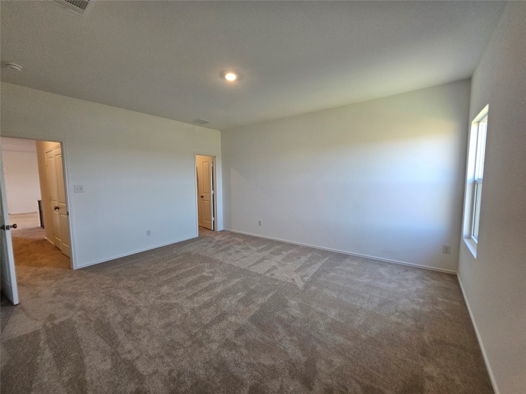 856 Rancho Del Cielo Loop Jarrell, TX 76537 - Photo 18 of 35 a view of an empty room and a window