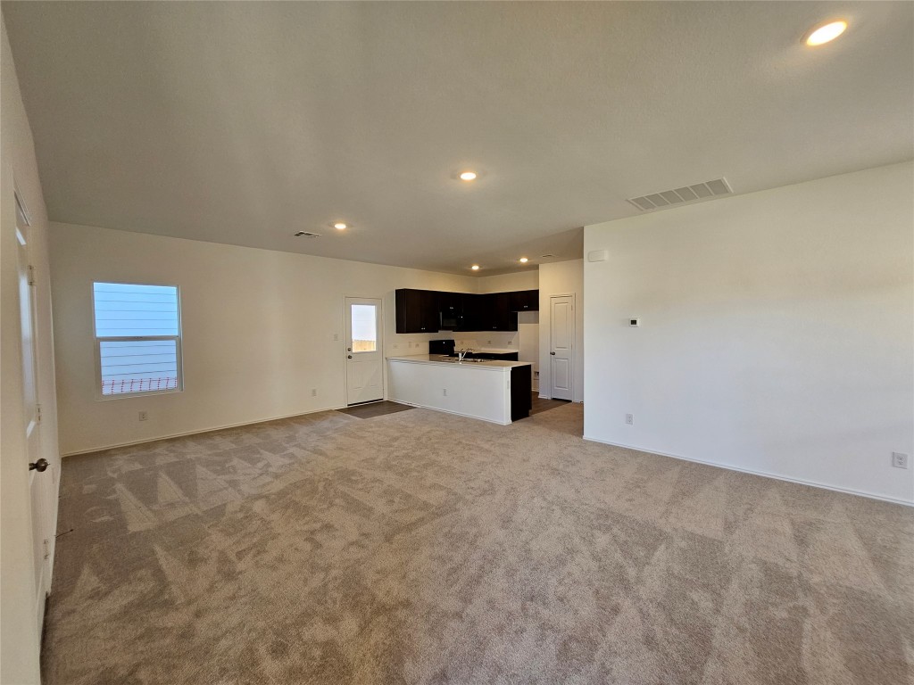 856 Rancho Del Cielo Loop Jarrell, TX 76537 - Photo 2 of 35 a view of an empty room with a kitchen