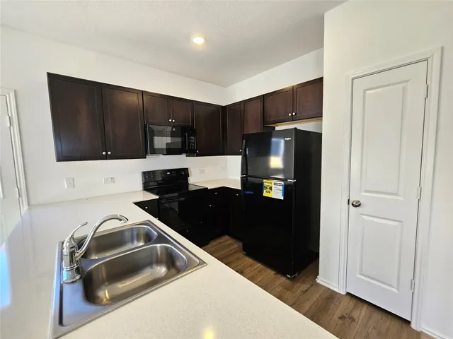 a kitchen with a refrigerator and a sink