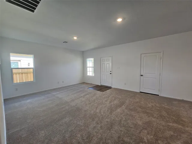 an empty room with windows and natural light
