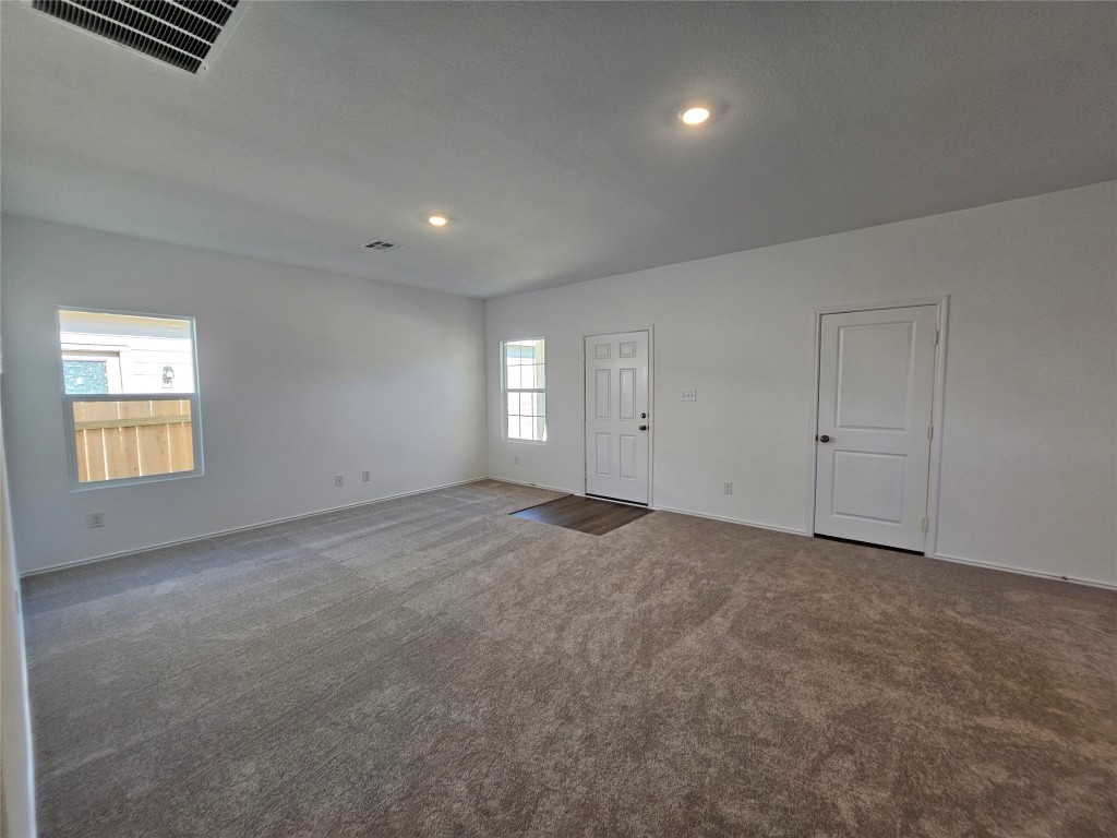 856 Rancho Del Cielo Loop Jarrell, TX 76537 - Photo 5 of 35 an empty room with windows and natural light