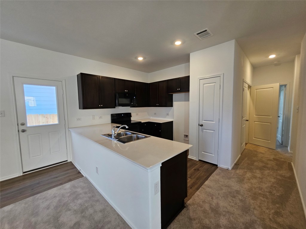 856 Rancho Del Cielo Loop Jarrell, TX 76537 - Photo 7 of 35 a kitchen with stainless steel appliances a sink stove and refrigerator