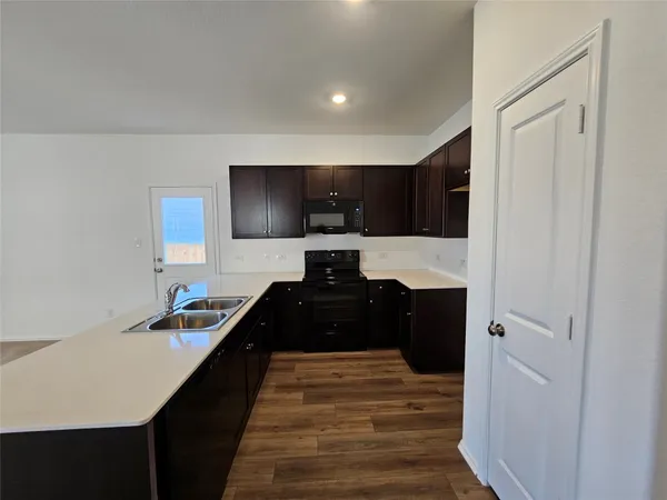 a kitchen with a sink and a stove top oven