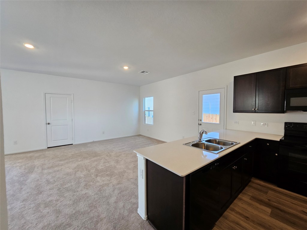856 Rancho Del Cielo Loop Jarrell, TX 76537 - Photo 9 of 35 a kitchen with a sink cabinets and microwave