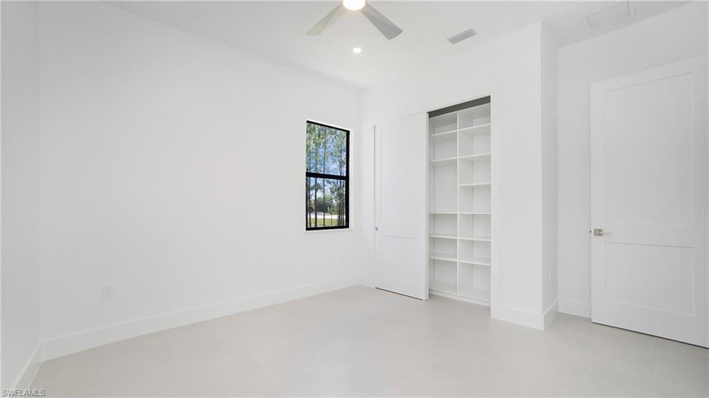 2343 Oil Well Road Naples, FL 34120 - Photo 16 of 46 Bright interior space featuring a window with black trim, recessed lighting, and a ceiling fan