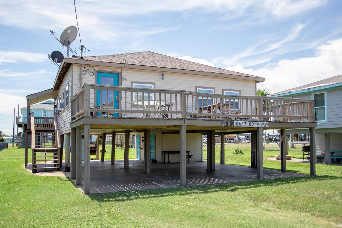 959 South East Road Crystal Beach, TX 77650 - Photo 2 of 20 a front view of a house with swimming pool yard and outdoor seating