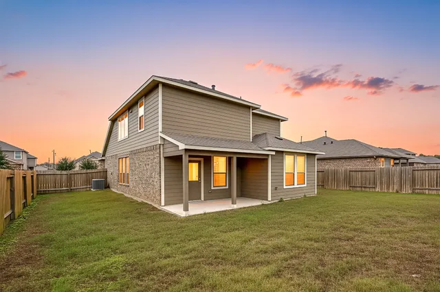 a front view of house with a yard and trees