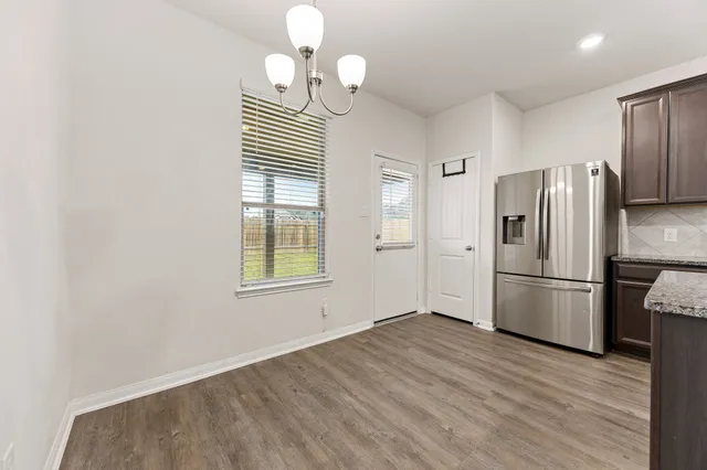 a view of a hallway with windows and stairs