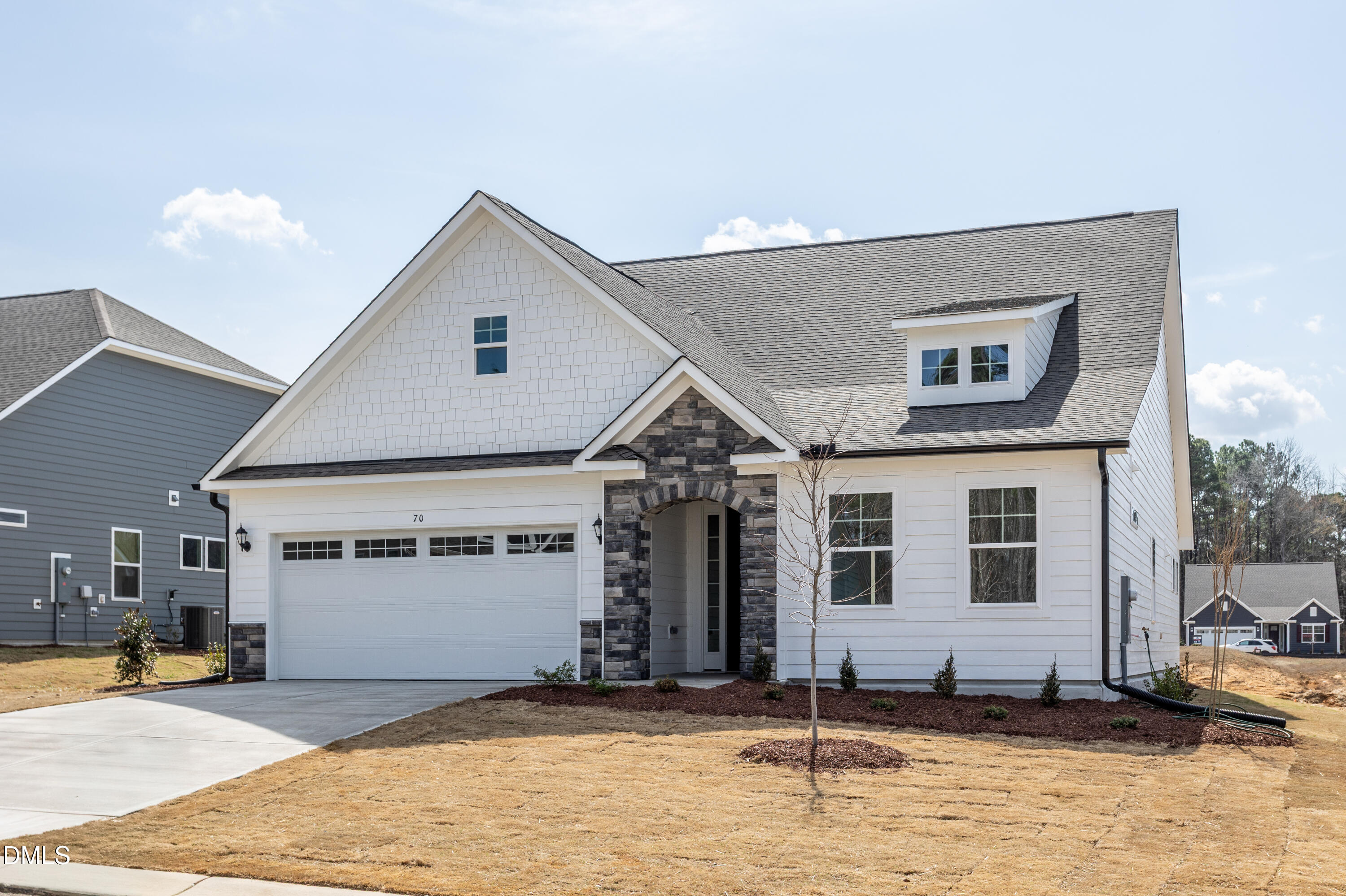 70 Slippery Elm Road Youngsville, NC 27596 - Photo 2 of 32 a front view of a house with a garage