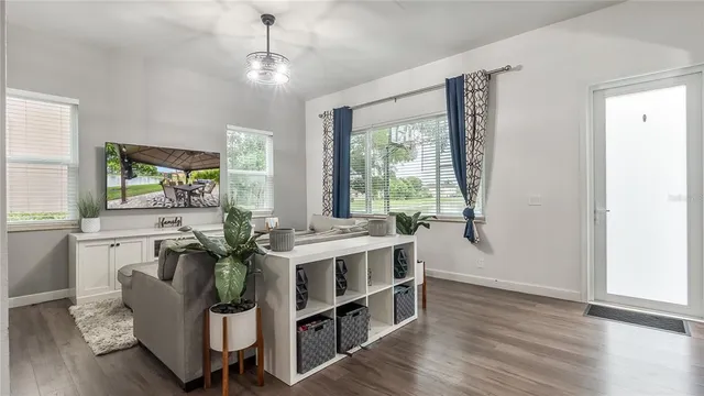 a living room with furniture and a wooden floor