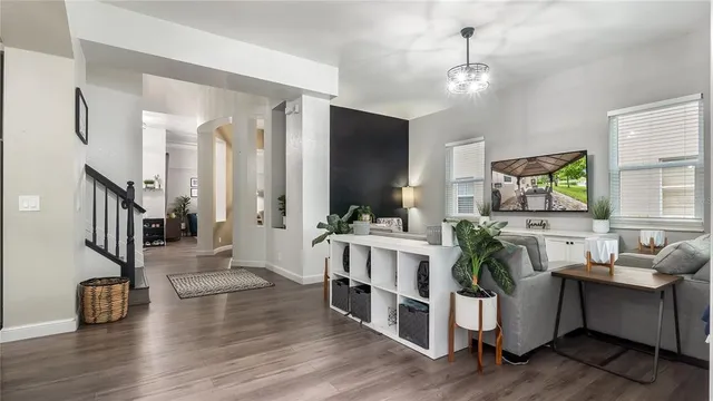 a living room with furniture and a wooden floor
