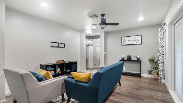 a living room with furniture and a potted plant