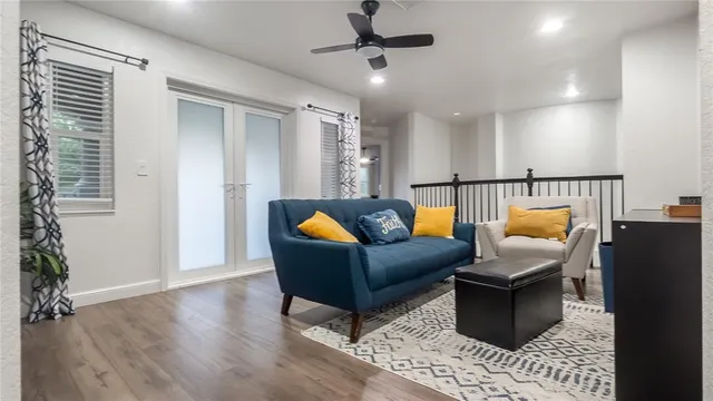 a living room with patio furniture and a potted plant
