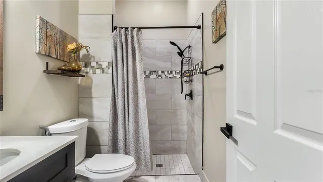 a spacious bedroom with a bed and glass window