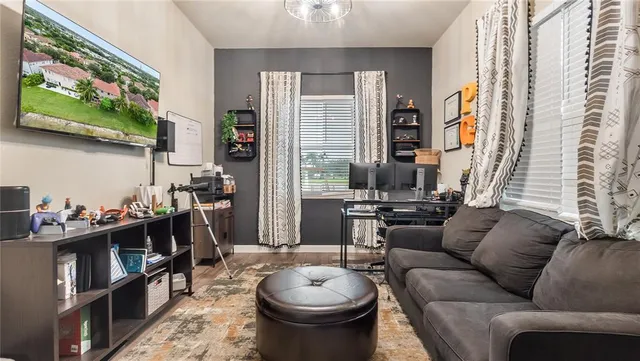 a bedroom with a bed and a chandelier