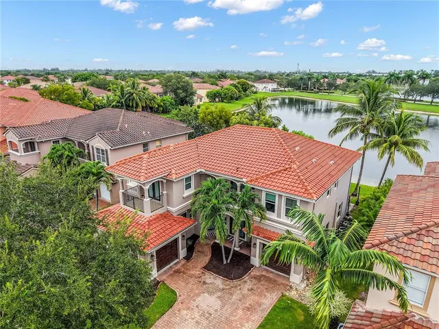 an aerial view of house with yard and ocean view
