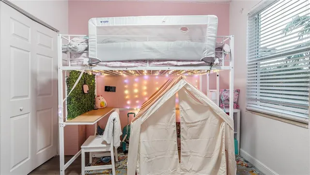 a spacious bedroom with a bed and a large window