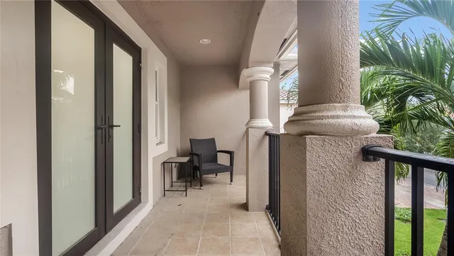 an aerial view of residential house with outdoor space and trees all around