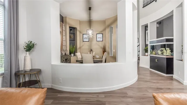 a living room with furniture a fireplace and a chandelier