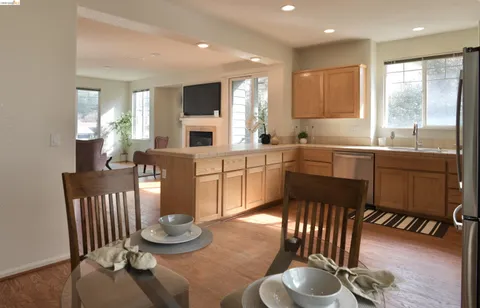 a kitchen with sink table and chairs