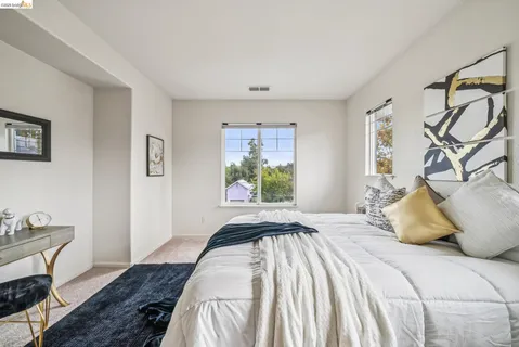 a bedroom with a large bed and a window