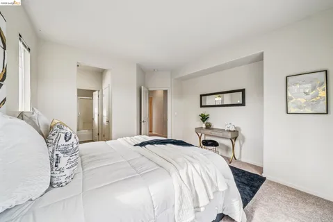 a bedroom with a bed and a mirror
