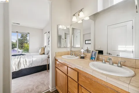 a bathroom with a double vanity sink mirror and double
